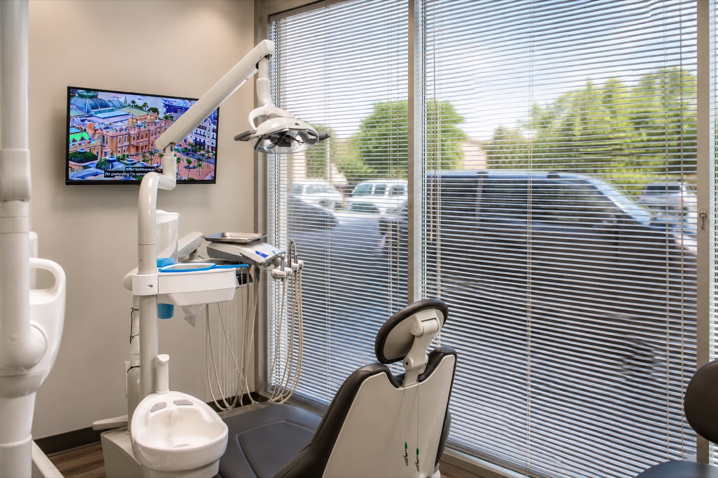 A treatment room at Avant Garde Dental with chair, overhead light and window
